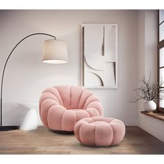 a pink chair and footstool in a white room