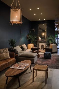 a living room filled with furniture and a fire place in the middle of it's walls