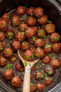 the meatballs are being cooked in the slow cooker