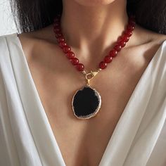 R E D ∙ C A R N E L I A N ∙ N E C K L A CE 💎Features: * Material: Natural Red Carnelian Beads,Natural Black Agate, Brass Clasp-Gold Plated, Tarnish Free * Gemstone Grade: AAAAAAA, High Quality genuine gemstone. * Beads Size: 12mm large size * Pendant Size:  * Color: Rich, lustrous red beads, Black Agate Pendant, 14K Gold color for hardware * Detachable Pendant for versatile styling: Wear it for bold or remove for minimalist elegance. Switch effortlessly between 2 styles. * Length: 16 to 26 inch Luxury Elegant Carnelian Beaded Necklaces, Red Agate Gemstone Beaded Necklace, Red Agate Jewelry With Natural Stones, Red Agate Pendant Necklace, Red Crystal Necklace With Natural Stones, Red Crystal Pendant Necklace With Natural Stones, Red Agate Gemstone Necklace, Red Natural Stone Crystal Pendant Necklace, Red Agate Round Bead Crystal Necklaces