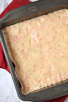 a cake batter in a pan with sprinkles on the top, ready to go into the oven