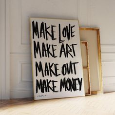 a sign that says make love make art make out make money in front of a white wall