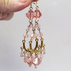 Make a stunning statement with this exquisite pair of extra-long peach crystal chandelier earrings, designed for those who appreciate the artistry of handcrafted jewelry. Each pair is meticulously crafted with luxurious 14kt gold filled wire, featuring a chic goldtone connector station that enhances their elegance. The sparkling faceted peach crystal beads catch the light beautifully, creating a dazzling display that's simply spectacular. Perfect for special occasions, holiday parties, or any time you want to add a bold and flirty flair to your ensemble, these earrings are sure to turn heads and spark conversations. Their eye-catching design and radiant color make them a standout accessory that will elevate any outfit. Measuring a full 3 inches in length, including the 14kt gold filled ear Bead Connectors Jewelry Making, Crystal Chandelier Earrings, Party Earrings, Long Dangle Earrings, 14kt Gold, Crystal Chandelier, Chandelier Earrings, Extra Long, Holiday Parties