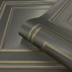 a close up view of a gray and gold colored wallpaper with lines on it