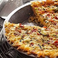 an omelet is sitting on a pan with a slice cut out and ready to be eaten