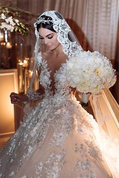 a woman in a wedding dress holding flowers