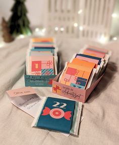 several pieces of paper with numbers on them sitting on a bed next to a christmas tree