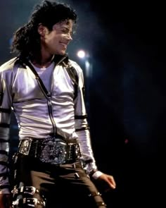 michael jackson performing on stage with his belt around his waist and wearing an elvis costume