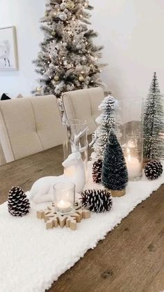 a dining room table decorated for christmas with pine cones and candles