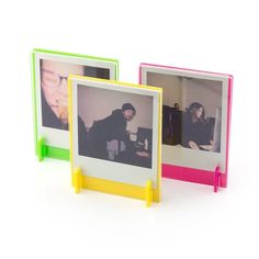 two small frames with photos on them sitting next to each other