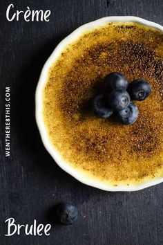 three blueberries in a white bowl with the words creme written above it and below