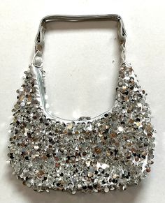 Sequin Handbags are hand-made, high quality, original designs, and beautiful. They are unique for evenings and special events and their designs are inspired by contemporary fashion and vintage looks. Sequin handbags are a perfect balance of aesthetics and functionality. Glamorous Summer Clutch Bag, Trendy Party Hobo Bag, Trendy Hobo Shoulder Bag For Party, Silver Satchel Shoulder Bag, Trendy Hobo Bag For Party, Glamorous Rectangular Summer Bags, Luxury Hobo Shoulder Bag For Party, Trendy Handheld Shoulder Bag For Party, Elegant Silver Hobo Shoulder Bag