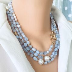 "Introducing a stunning masterpiece of jewelry, the Hand Knotted Baroque Blue Lace Agate & Fresh Water Pearls Necklace. This exquisite necklace features a mesmerizing combination of natural shaded lace agate beads and lustrous freshwater pearls, meticulously hand-knotted to create a breathtakingly beautiful design. With a remarkable length of 58 inches, this unique necklace offers endless layering possibilities, allowing you to effortlessly elevate your style and create stunning statement looks. The gold-plated accents add a touch of luxury to this handmade jewelry piece, making it the perfect mother's day gift, birthday gift or Christmas Gift for her, Valentine's Day Gift... Surprise your loved one or treat yourself to this exceptional necklace that promises to make any outfit shine. MATE Elegant Multi-strand Gemstone Necklaces, Elegant Multi-strand Gemstone Beaded Necklace, Elegant Multi-strand Beaded Necklaces With Gemstones, Elegant Double Strand Long Necklace With Natural Stones, Elegant Chalcedony Jewelry With Natural Stones, Elegant Long Necklace With Round Natural Stones, Blue Chalcedony Bead Necklaces, Blue Multi-strand Gemstone Necklaces, Blue Gemstone Multi-strand Necklaces