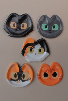 four cat magnets with different designs on them