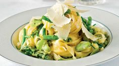 a white plate topped with pasta and veggies