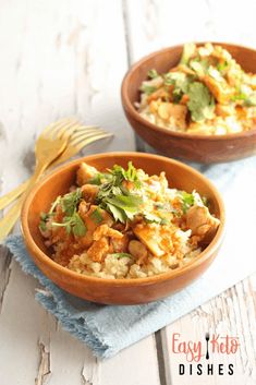 two wooden bowls filled with rice and vegetables