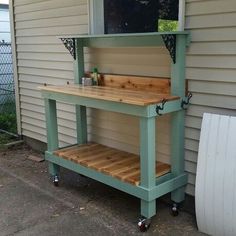 an outdoor kitchen made out of pallet wood and metal with wheels on the outside