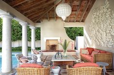 an outdoor living area with wicker furniture and large white balls hanging from the ceiling