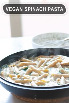 a pan filled with pasta sitting on top of a table