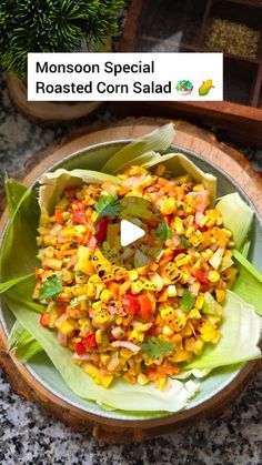 a bowl filled with corn salad on top of a wooden table next to a potted plant