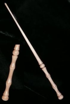 two wooden mallets sitting next to each other on a black surface