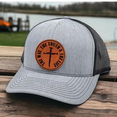 Get ready to hit the road with this high-quality Jesus Trucker Hat! Designed with a leather patch, this hat is perfect for any Christian dad. Show off your faith while staying cool and stylish. The perfect gift for Father's Day or any occasion. PRODUCT INFORMATION: - Richardson 112 Trucker Hat - Size: Unisex - 6 panel construction delivers classic trucker style - Adjustable snapback for a custom fit - A cotton sweatband provides all-day comfort - High quality round leather patch - Engraved by la Photo Engraving, Round Leather, Leather Patches, Hat Sizes, Gifts For Father, Trucker Cap, The Truth, Custom Fit, Fathers Day Gifts