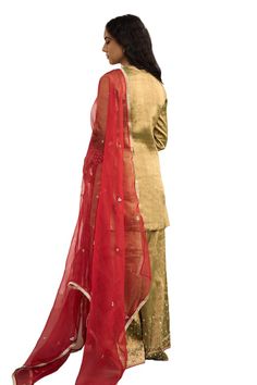 Green kurta with placement hand embroidery. Paired with a sharara with hand embroidered hem and red dupatta with embroidered buttis. - Aza Fashions Festive Traditional Tissue Silk Palazzo Set, Gold Cotton Silk Palazzo Set With Sheer Dupatta, Gold Art Silk Palazzo Set For Diwali, Gold Palazzo Set With Sheer Dupatta In Cotton Silk, Diwali Gold Art Silk Palazzo Set, Designer Gold Slub Silk Palazzo Set, Gold Slub Silk Sharara With Zari Work, Traditional Gold Cotton Silk Palazzo Set, Festive Palazzo Set With Pallu In Tissue Silk