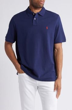 The label's iconic embroidered logo adds charm to a short-sleeve polo crafted from airy cotton piqué for comfort during your days off. 28" length (size Medium) Rib collar Short sleeves with rib cuffs 100% cotton Machine wash, tumble dry Imported Classic Navy Cotton Polo Shirt, Navy Cotton Short Sleeve Polo Shirt, Navy Sporty Moisture-wicking Polo Shirt, Blue Cotton Polo Collar T-shirt, Navy Cotton Moisture-wicking Polo Shirt, Short Sleeve Polo, Newport, Polo Ralph Lauren, Ralph Lauren