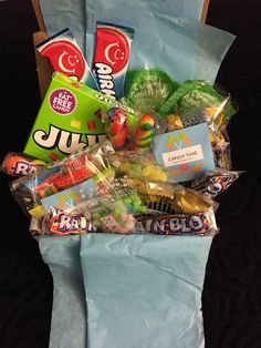 a bag filled with candy and candies on top of a blue paper wrapper