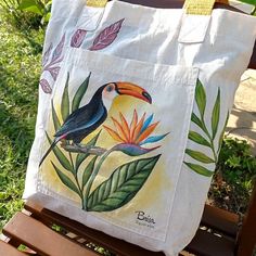 a tote bag sitting on top of a wooden bench