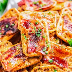 a plate full of waffles with toppings on them and garnished with parsley