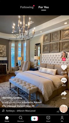 a bed room with a neatly made bed and a chandelier