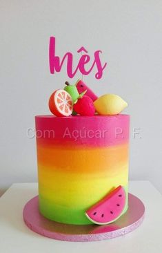 there is a colorful cake with fruit on it