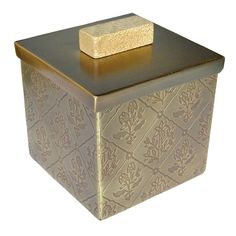 a gold and silver box with a wooden block sitting on it's top,