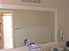 a woman taking a selfie in front of a bathroom mirror with the reflection of herself