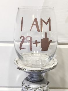 a wine glass with the words i am 29 + 2 on it sitting on a pedestal