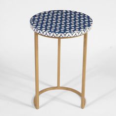 a blue and white patterned stool with wooden legs on a white background, it has a circular shaped seat that is made out of wood