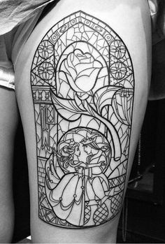 a woman with a stained glass tattoo on her thigh