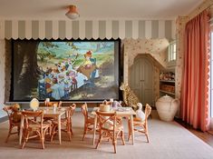 the children's playroom is decorated in pink and white striped walls, along with an art work on the wall