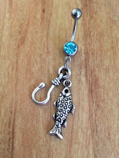 a fish belly ring with a blue jewel on it