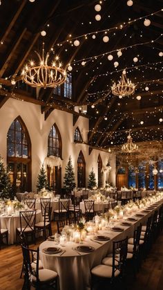 a large banquet hall with tables and chandeliers in the ceiling, decorated for christmas