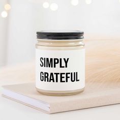 a glass jar with the words simply grateful on it