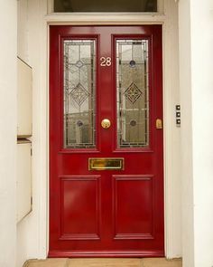 a red front door with two glass panels