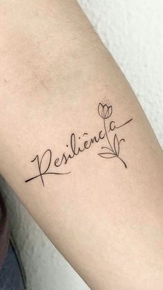 a woman's arm with a tattoo that reads, resilina