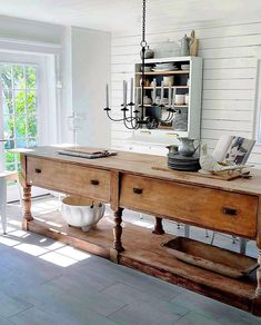 a wooden table sitting in the middle of a room