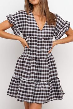 Make the most of your summer in this graceful plaid swing dress with an elegant tiered design. This airy dress keeps you cool throughout the hot days while boosting your confidence wherever you go. True to size V neck Ruffled details, tiered Material: 100% cotton Care: Hand wash cold. Do not tumble dry. Imported White Tiered Dress, Tiered Dresses, Airy Dress, Tier Dress, Short Sleeve Pattern, Ruffle Shorts, Gathered Skirt, Dress Gift, Black Ruffle