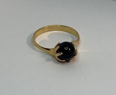 Superb iconic ring from the Charles Jourdan brand. Small model. In gold plated, representing hands gripping an onyx stone. Size: 54EUR /17.1mm In very good vintage condition - slight signs of use. Gold Onyx Rings With Polished Finish, Gold Onyx Jewelry For Anniversaries, Gold Onyx Jewelry For Anniversary, Classic Gold Onyx Rings, Minimalist Gold Onyx Ring, Modern Gold Ring With Round Stone, Modern Gold Rings With Round Stone, Formal Gold Onyx Rings, Gold Cabochon Ring With Round Stone