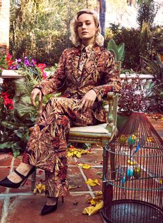 a woman sitting in a chair next to a birdcage on the cover of instyle magazine