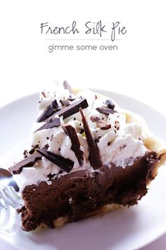 a piece of chocolate pie with whipped cream and chocolate shavings on the top