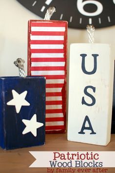 patriotic wood blocks with the word usa painted on them and an american flag sign next to it